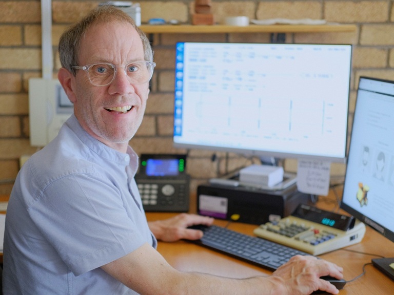 Here's Greg. Seen here behind an all-important calculator. There may be some screens and a phone too, but it's the calculator that's important.