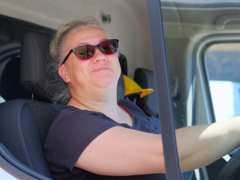 Mini, our amazing lorry driver and logistics genius. She is sitting in her lorry, keen to get her deliveries done!