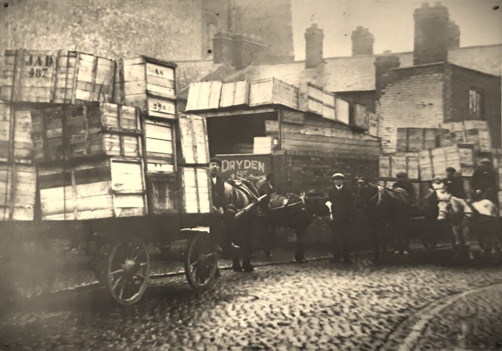 Photo of Siddons Packaging in c1900 at Wharf Street / Dryden Street, in Leicester. Wooden crates loaded on horse driven carts on the cobbled streets.