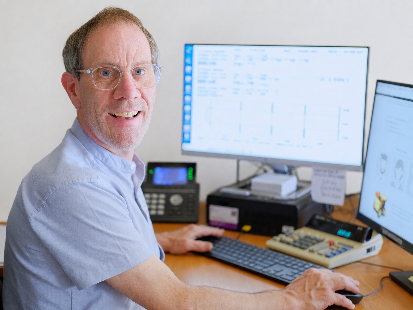 Here's Greg. Seen here behind an all-important calculator. There may be some screens and a phone too, but it's the calculator that's important.