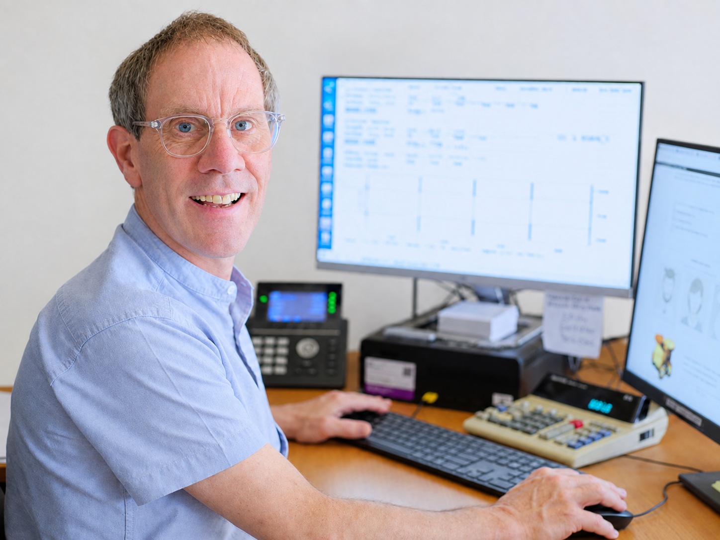 Here's Greg. Seen here behind an all-important calculator. There may be some screens and a phone too, but it's the calculator that's important.